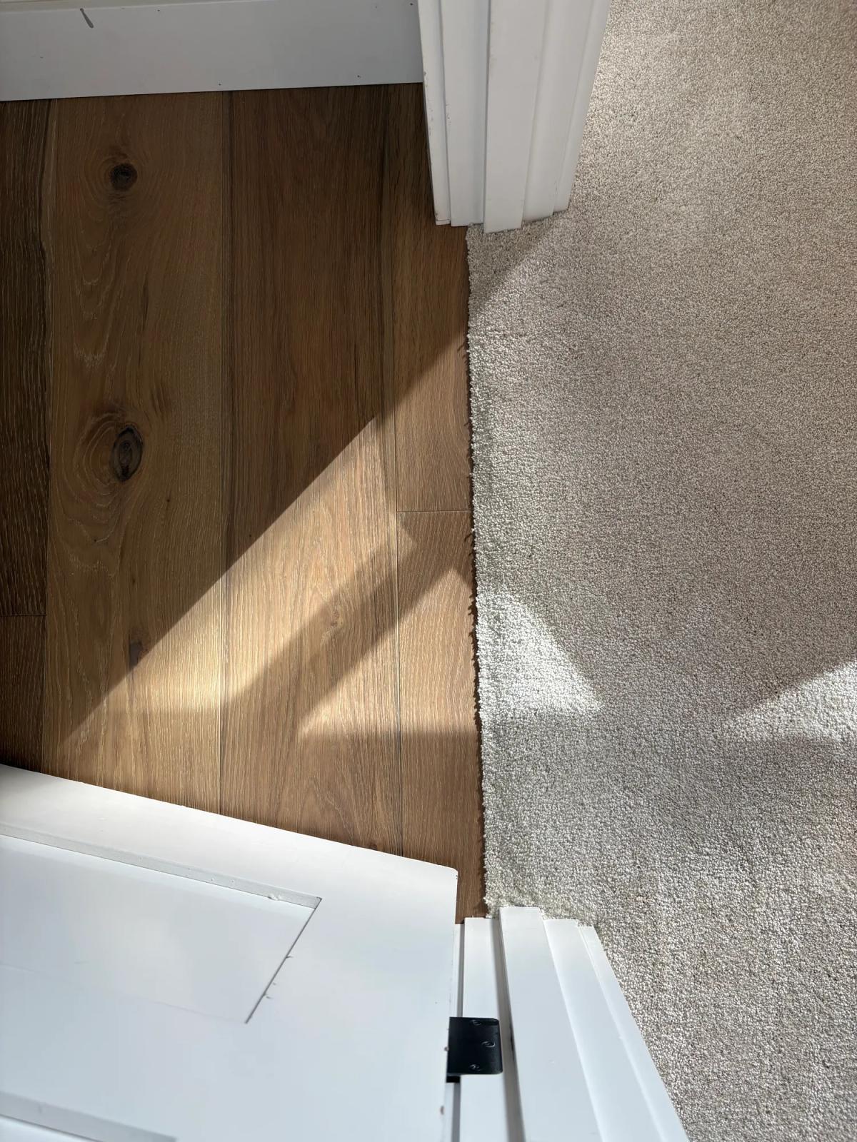 Tight carpet edge at the doorway next to the hardwood