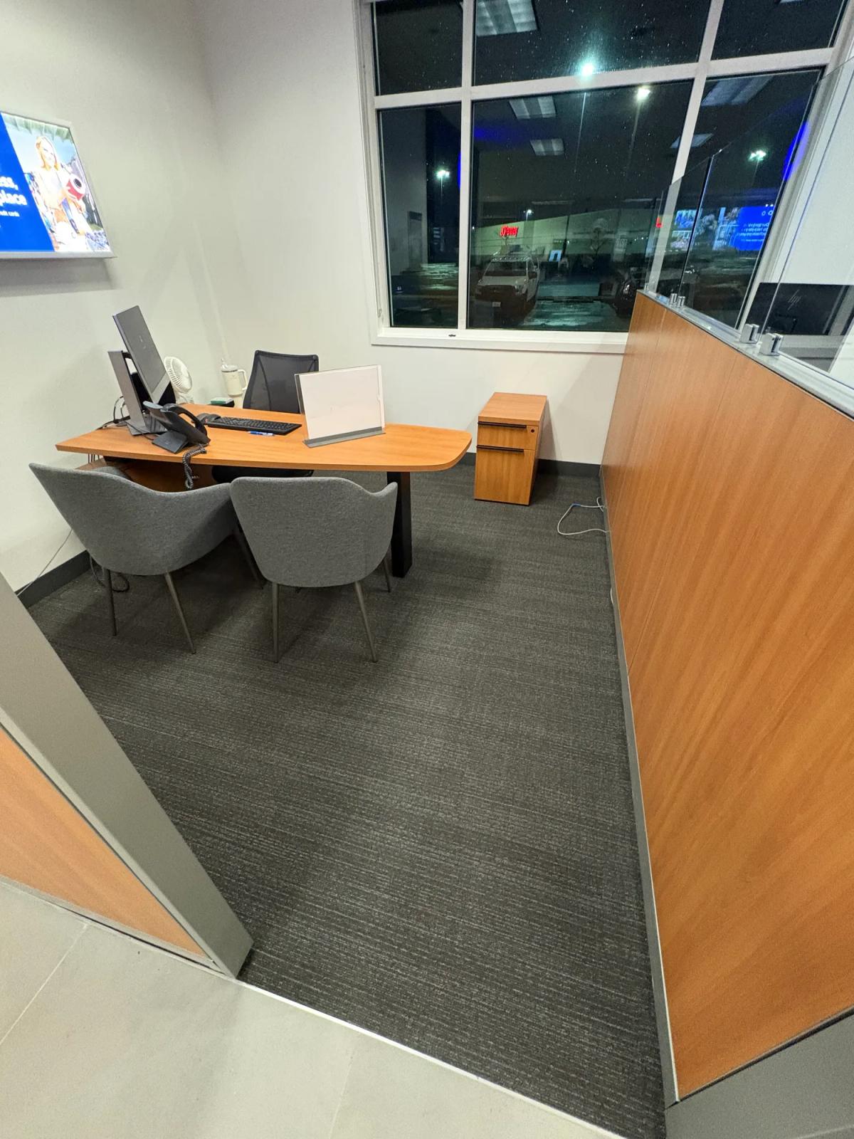 Private office with new carpet tile and clean edges at the glass wall